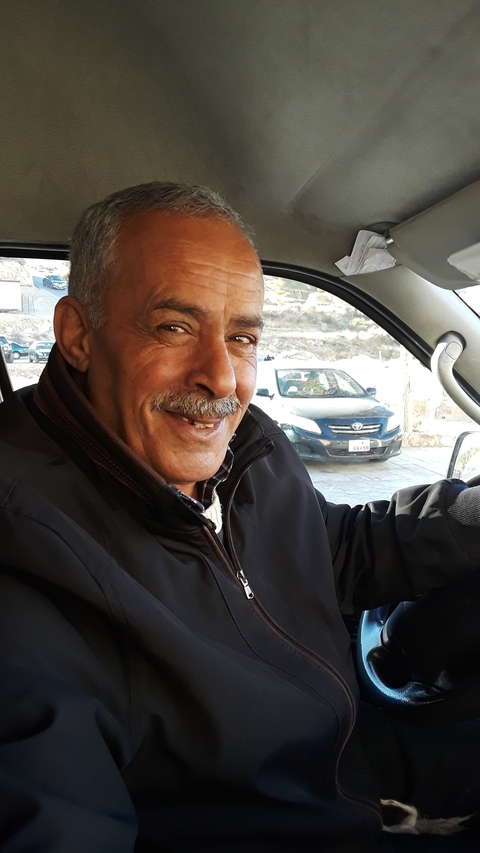       Smiling person inside a vehicle.
  