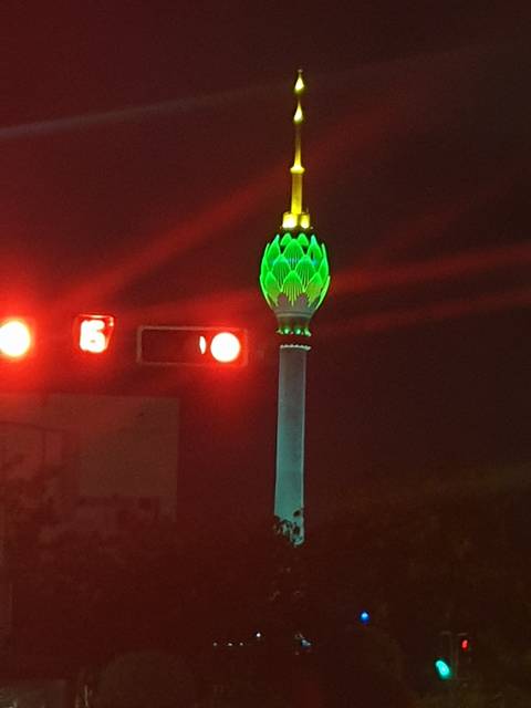 Tall structure with colorful lighting at night.