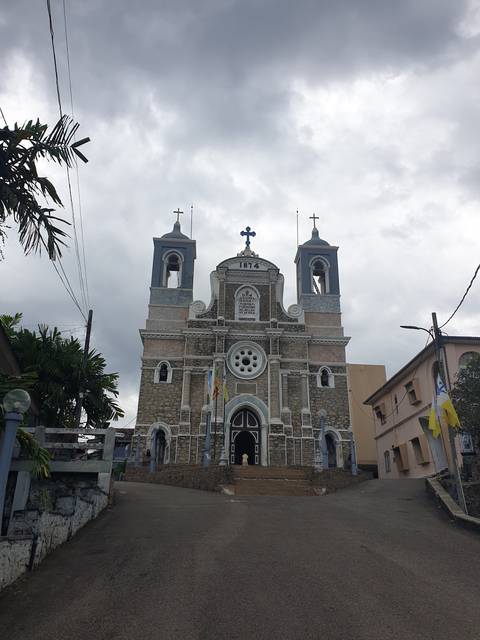       Church building with cloudy sky in the background.
  
