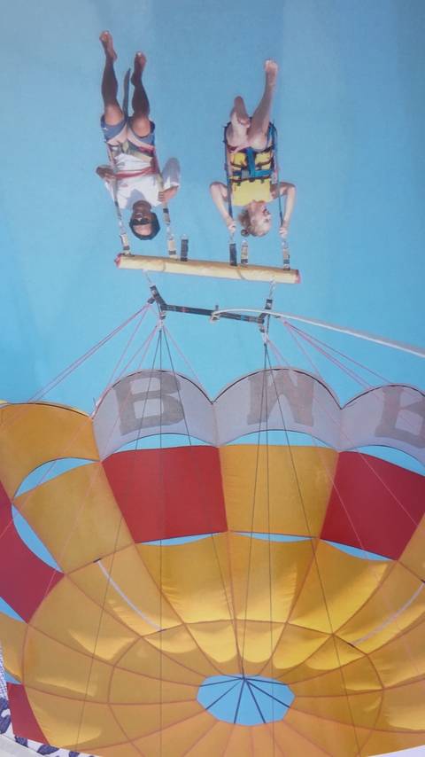 Colorful parasail against a clear sky.