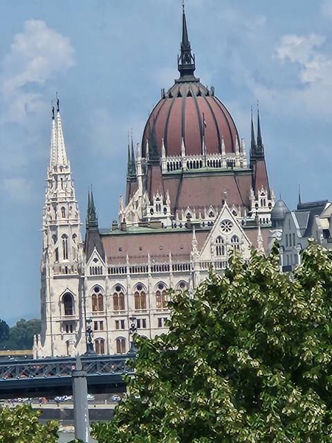       A side view of a large domed building with ornate architectural details.
  