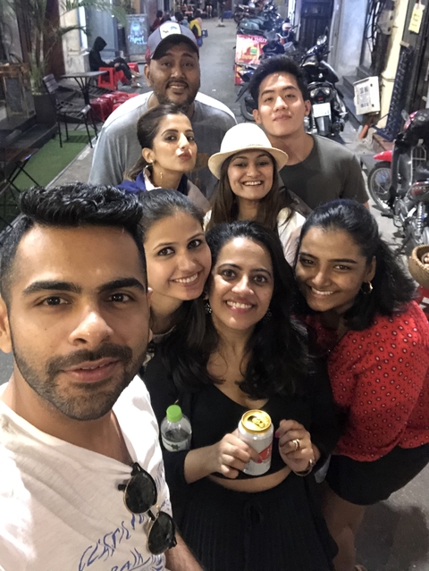 Group selfie of smiling friends.