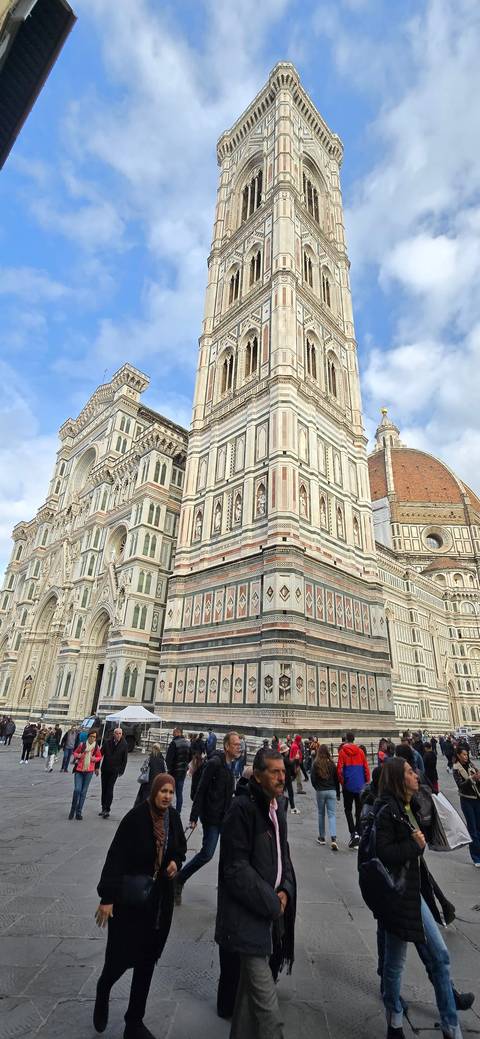 Florence Cathedral and Giotto’s Campanile with people walking.