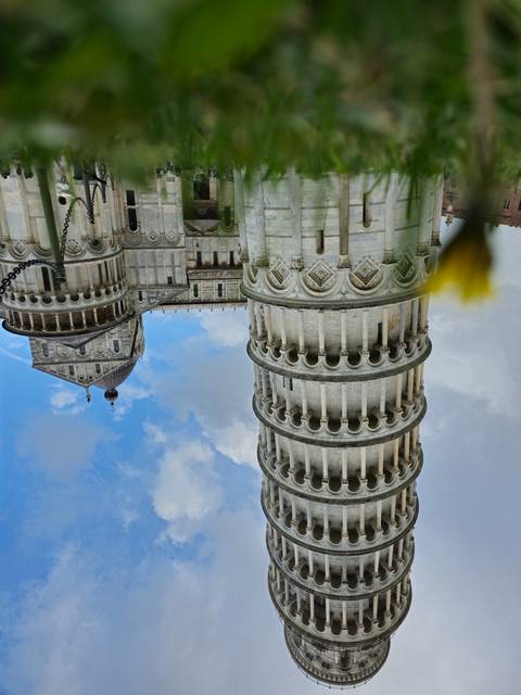 The Leaning Tower of Pisa with blue sky.