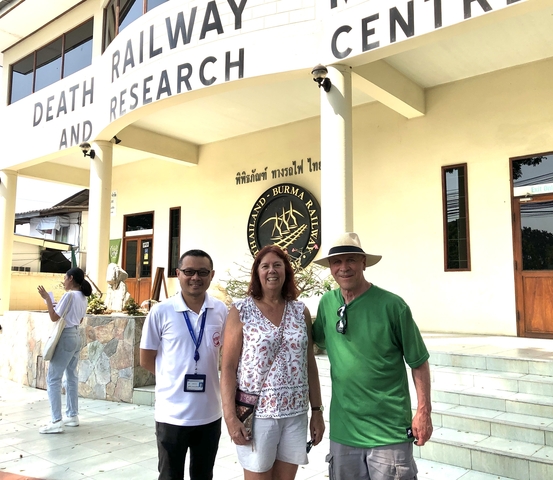 Tourists posing outside a building with historical significance.