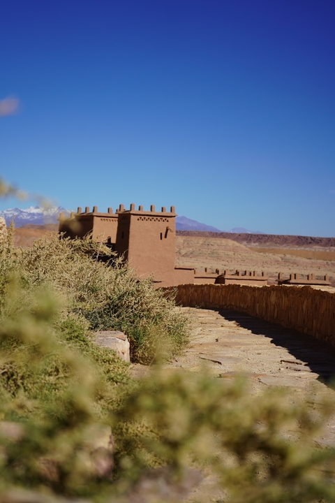 Traditional Moroccan architecture with mountains in the background.