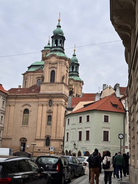 Street view with a historical church and pedestrians.