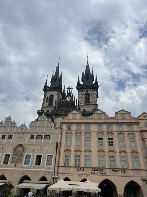       Square with historic buildings and a clock tower.
  