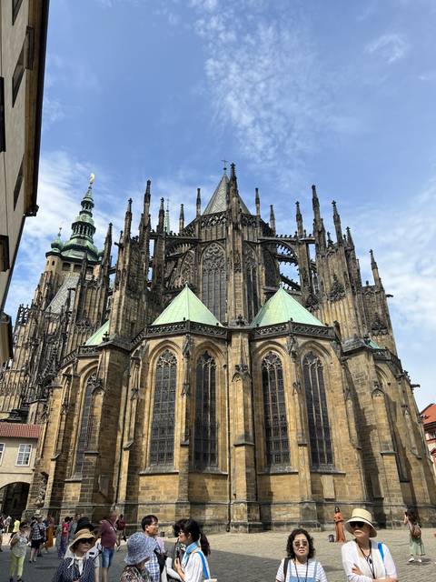 Gothic cathedral facade with tourists in the foreground.