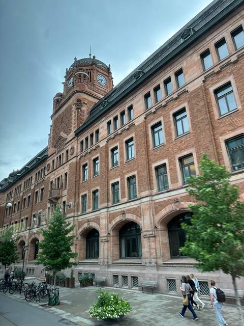 Clock tower and historic building in an urban setting.