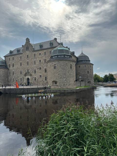 Stone castle with a reflection in the water.