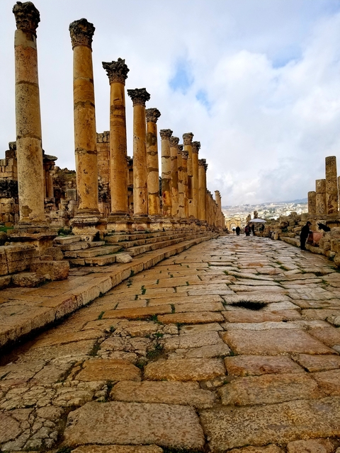       Ancient ruins with stone pillars and pathway.
  