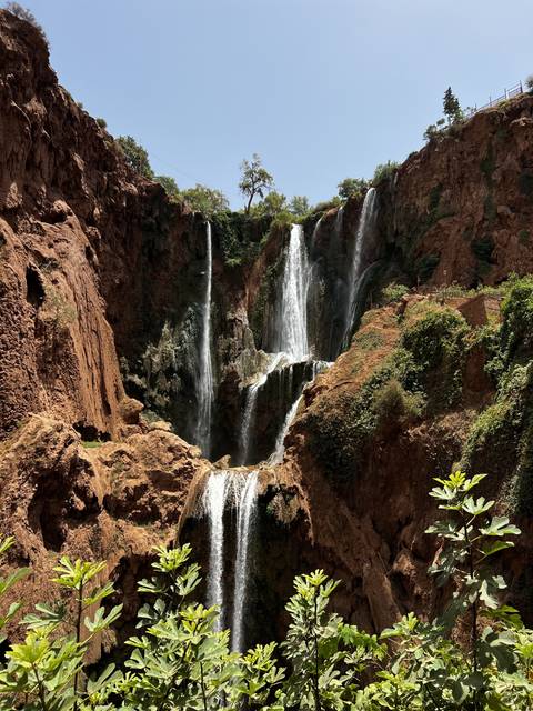 Waterfalls cascading down a rocky cliff.