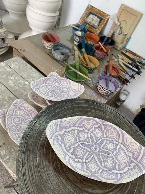       Decorative ceramic plates on a pottery wheel.
  