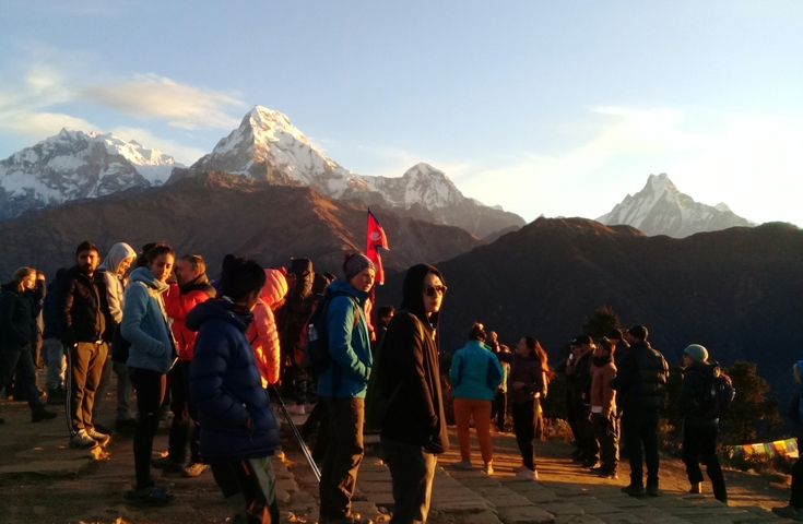 Group of people with mountains in the background.