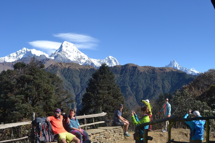 Group of hikers with snowy mountains in the background.