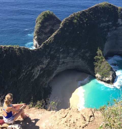 Scenic view of a coastal landscape with steep cliffs and turquoise water.
