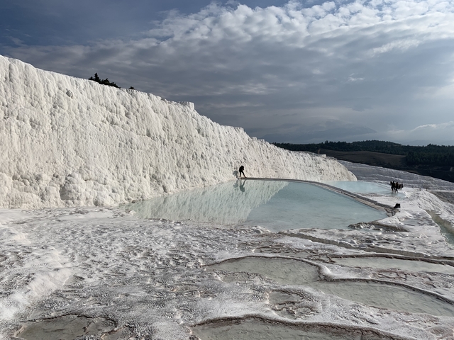 Bright white travertine terraces with pools of water.
