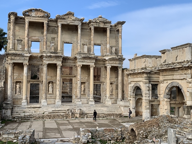       Ancient ruins with stone columns and statues.
  