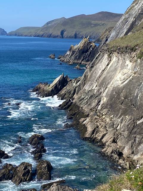       Rocky coast with waves crashing against the cliffs.
  