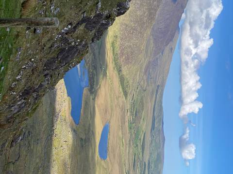       Expansive view of rolling hills and lakes.
  