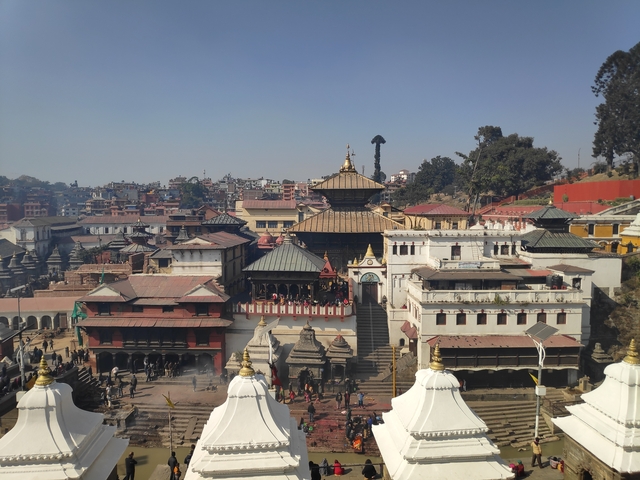       View of an ancient temple complex with crowded streets.
  
