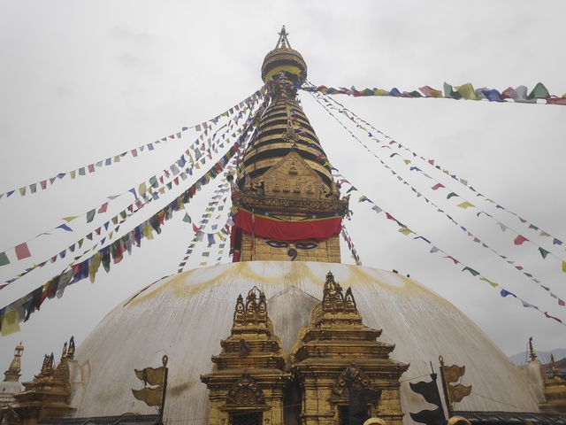       Traditional stupa with prayer flags against the sky.
  