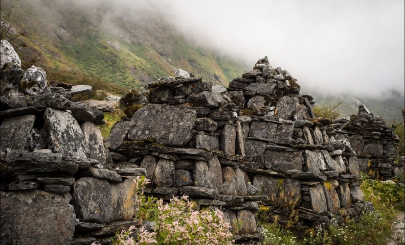       Ancient stone walls in a misty mountain landscape.
  