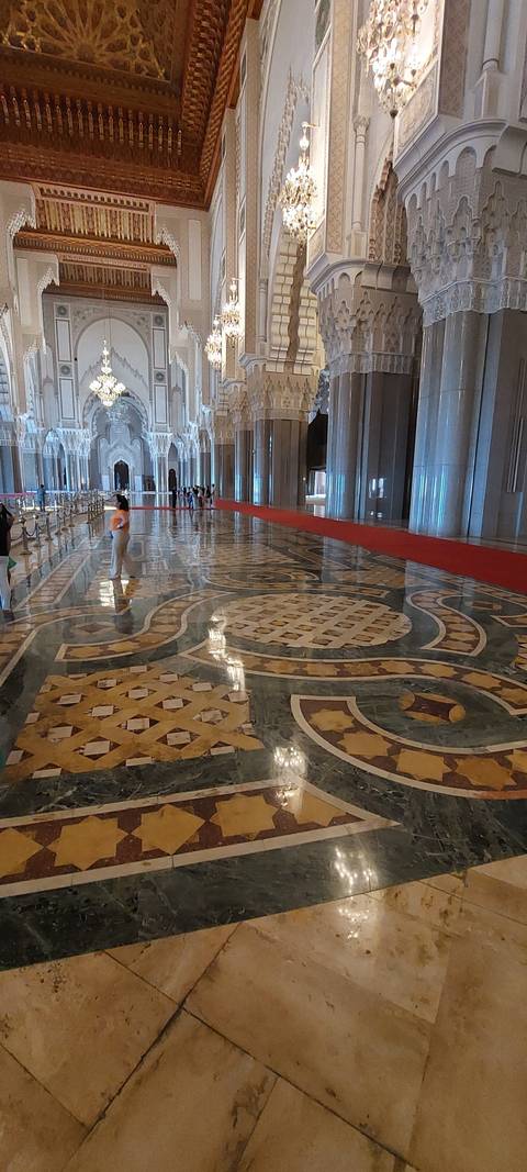       Ornate interior of a large mosque.
  