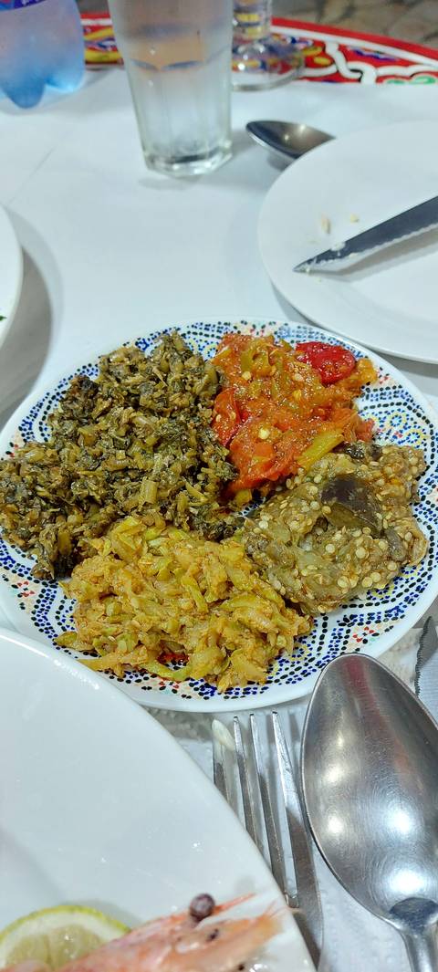 Moroccan side dishes in colorful bowls.