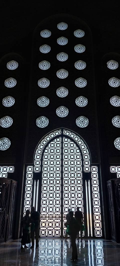       Intricate stained glass windows inside a building.
  