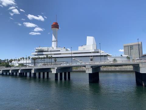       Upside-down image of a tower and building by the water.
  