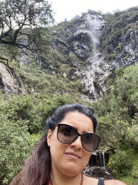       Close-up selfie with a waterfall in the background.
  