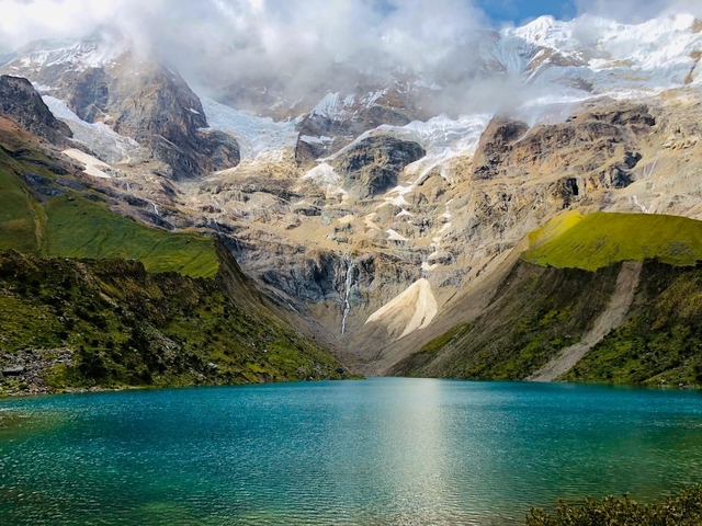       Vivid mountain landscape with a turquoise lake at the base.
  