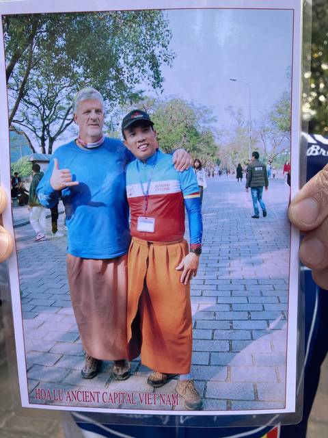       Printed photo of two people in traditional clothing.
  