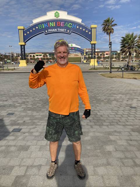 Person posing under a large sign at Bikini Beach.