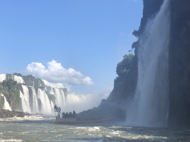 Spectacular view of Iguazu Waterfalls with visitors on a platform.