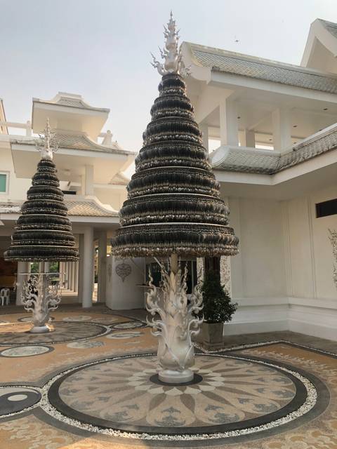       White temple with intricate sculptures.
  