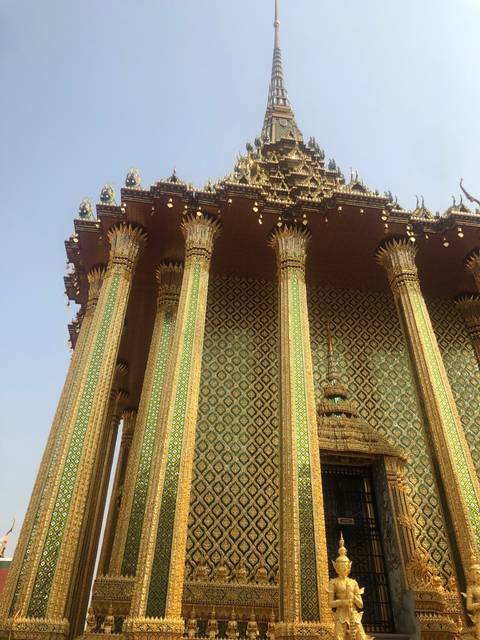       Temple with golden columns and intricate patterns.
  