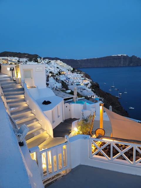       White-washed buildings and blue sea in Santorini.
  