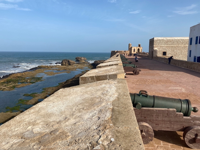       Historic coastal fortifications with cannons overlooking the sea.
  
