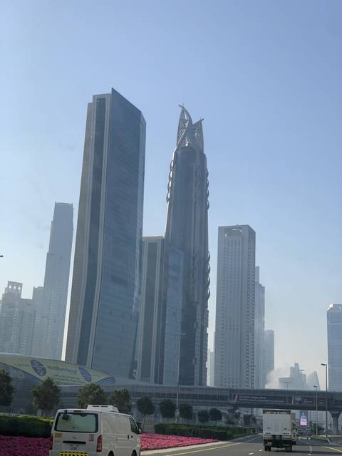Skyline of modern skyscrapers under a clear blue sky.