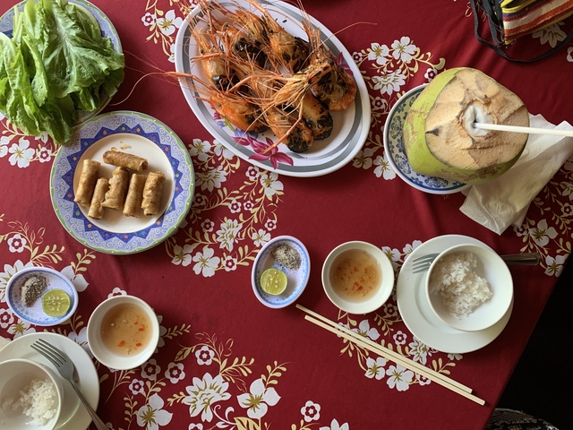       Vietnamese dishes arranged on a table with decorative cloth.
  