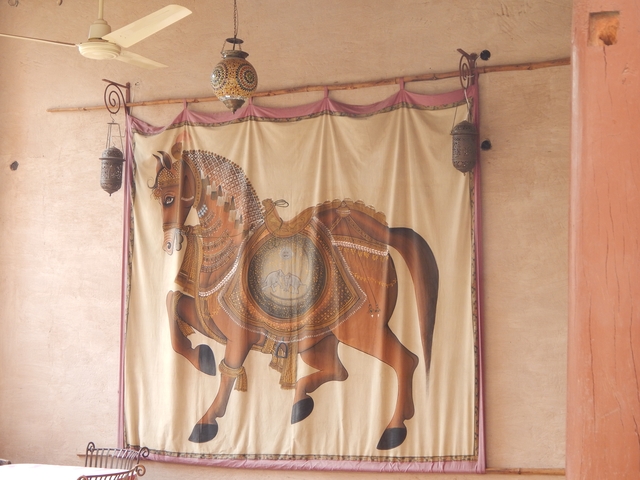 Decorative tapestry with a horse design.