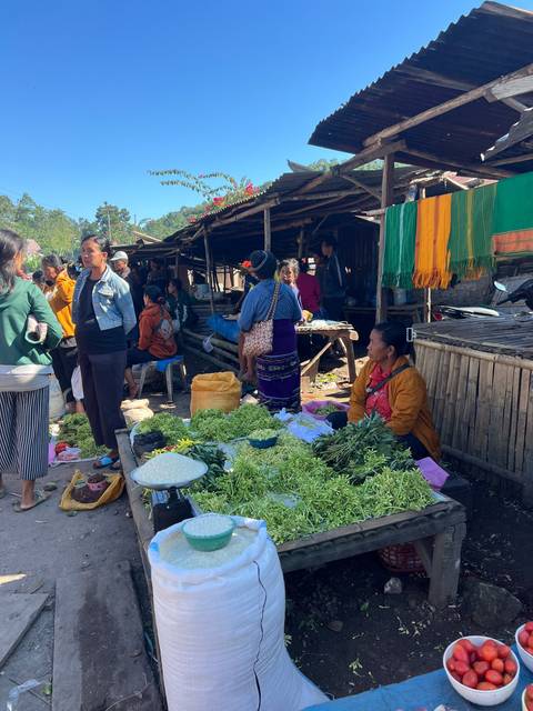 Upside-down market scene with various goods.