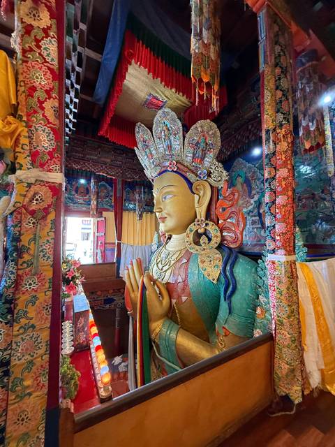       Ornate statue in a colorful temple interior.
  