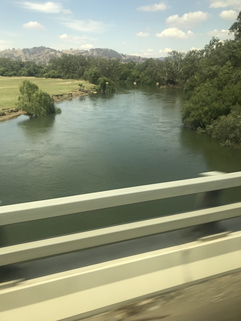 Water flowing under a road bridge.