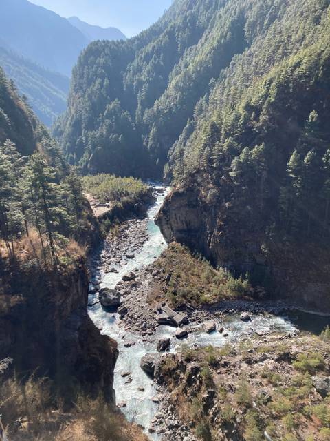 River running through a forested valley.