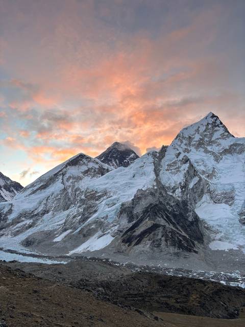 Snow-capped mountains with a colorful sunset sky.