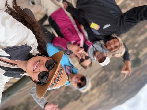       Group selfie with people wearing sunglasses and hats.
  